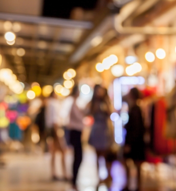 blurred photo of shoppers lingering outside or retail store front