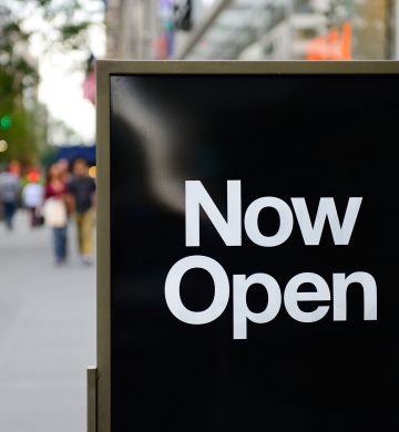 Now Open sandwich board on floor outside of retailer