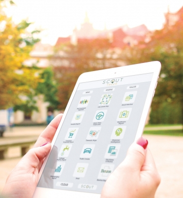 woman holding tablet device viewing SCOUT Touch for city government