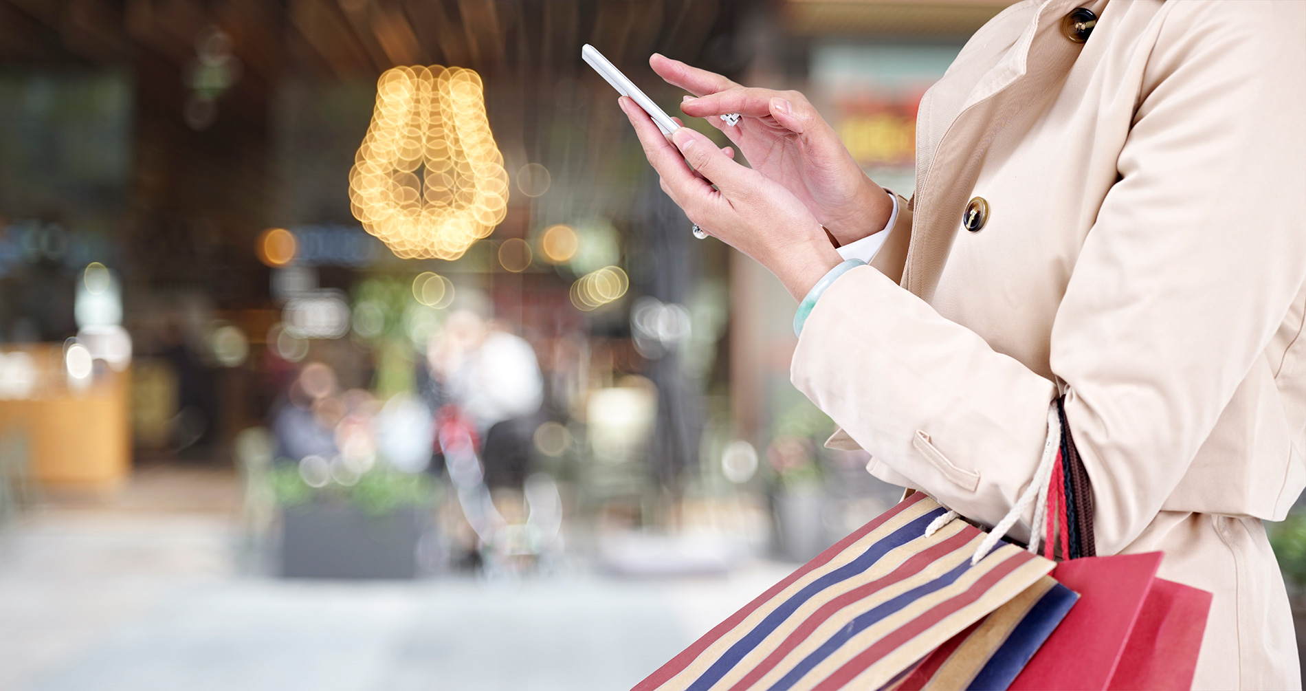 Woman using cellphone while shopping