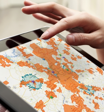 tablet with person reviewing a map and preparing to touch screen